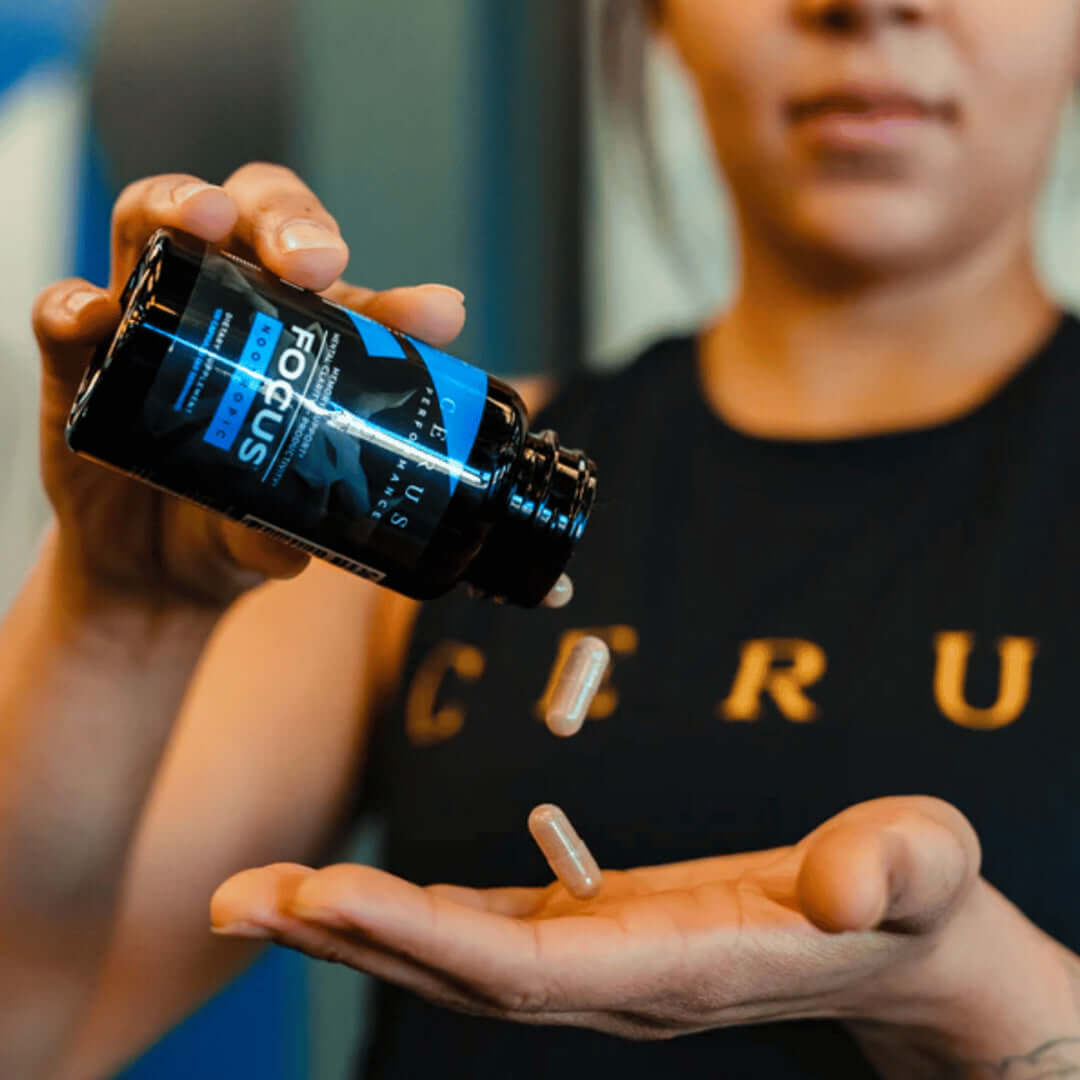 woman pouring pills out of a bottle of Focus nootropic